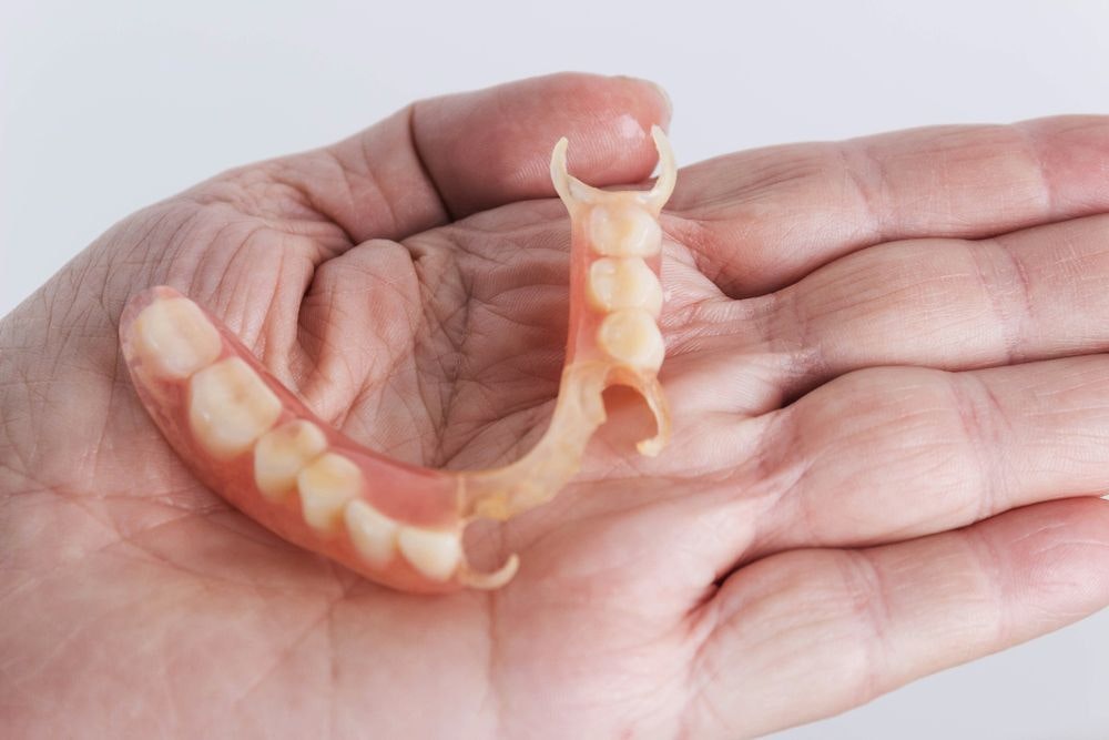 Partial denture in hand