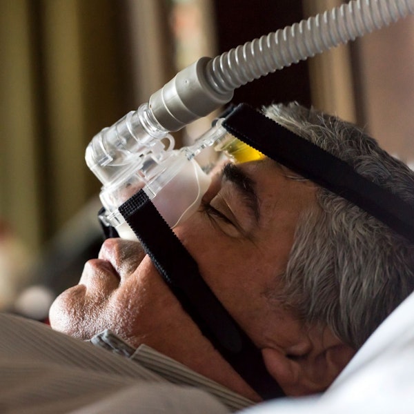 man wearing cpap device