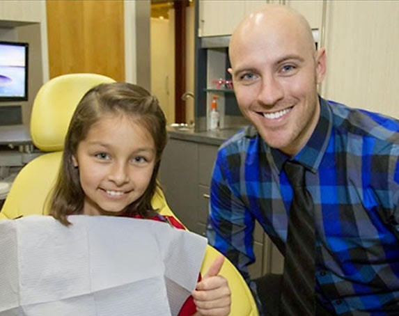 Dr. Terrance Wolbaum with a young patient